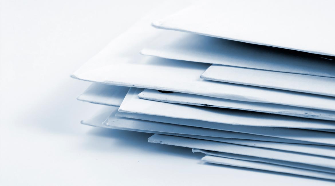 Stack of envelopes with paper statements inside